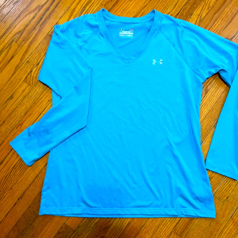 Women’s Under Armour long sleeved HeatGear workout top. Bright blue. Size Large.